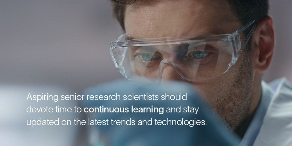 A senior research scientist wearing safety glasses closely examines something
